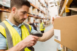 Warehouse worker scanning barcodes on boxes